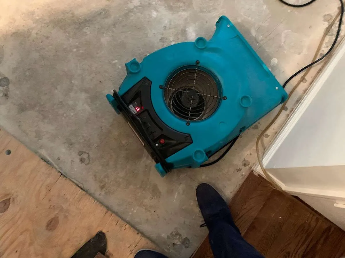 Air mover drying subfloor during Commercial Water Damage Restoration in West Caldwell
